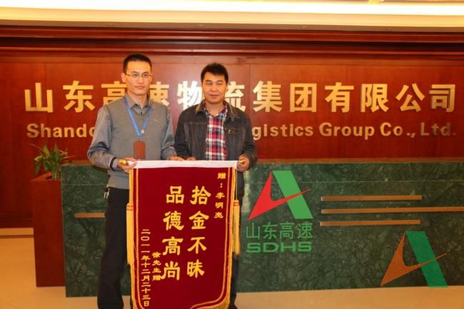失主徐先生将锦旗送到李明亮的手中